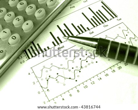 A small still-life about reporting - pen and calculator against the graph, in greens.