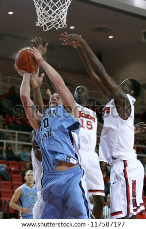 NEW YORK-NOV 3: Sonoma State Seawolves forward Brandon Glanz shoots a basket under St. John\'s Red Storm guard Sir\'Dominic Pointer (15) at Carnesecca Arena on November 3, 2012 in Jamaica, Queens, New York.