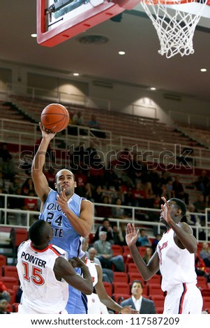 NEW YORK-NOV 3: Sonoma State Seawolves guard Patrick Scott shoots over St. John\'s Red Storm guard Sir\'Dominic Pointer (15) at Carnesecca Arena on November 3, 2012 in Jamaica, Queens, New York.