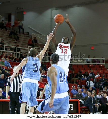 NEW YORK-NOV 3: St. John\'s Red Storm center Chris Obekpa (12) shoots over Sonoma State Seawolves guard Jason Walter (3) at Carnesecca Arena on November 3, 2012 in Jamaica, Queens, New York.