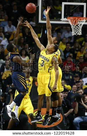 BROOKLYN-DEC 15: West Virginia Mountaineers guard Juwan Staten (3) shoots over Michigan Wolverines guard Trey Burke (3) during the first half at Barclays Center on December 15, 2012 in Brooklyn.