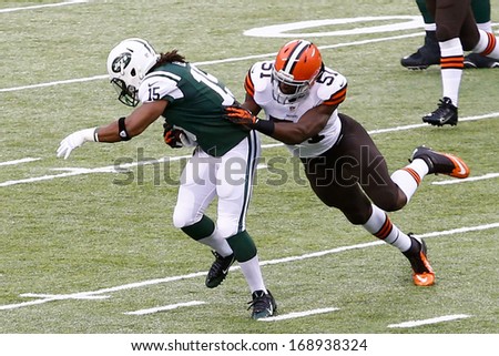 NEW YORK-DEC 22: Cleveland Browns outside linebacker Barkevious Mingo (51) attempts to tackle New York Jets wide receiver Saalim Hakim (15) during the first half at MetLife Stadium.