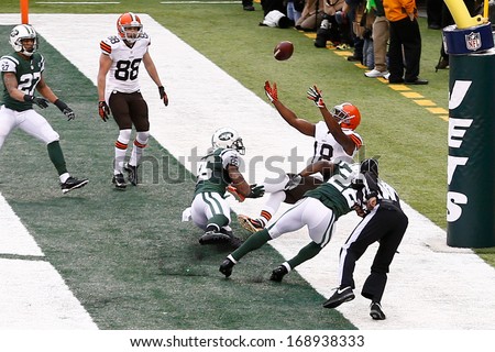 NEW YORK-DEC 22:  Cleveland Browns wide receiver Greg Little (18) leaps as New York Jets defensive back Aaron Berry (22) and safety Dawan Landry (26) defend during the first half at MetLife Stadium.