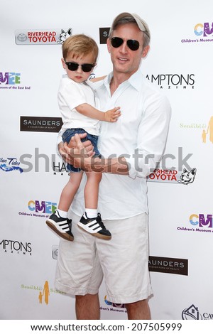 BRIDGEHAMPTON, NY-JUL 19: Actor Dan Abrams (R) and son Everett attend the 6th Annual Family Fair at the Children\'s Museum of the East End (CMEE) on July 19, 2014 in Bridgehampton, New York.