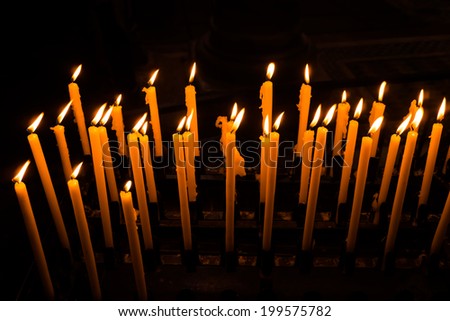 Church candle in a row.  Closeup of burning candle