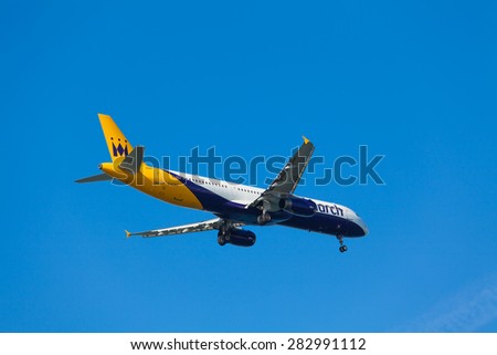 FARO,PORTUGAL-MAY 09 :Monarch Flights aeroplane lands at Faro International Airport,on May 09, 2015 in Faro,Portugal.Monarch is a British airline with 32 jet airliners