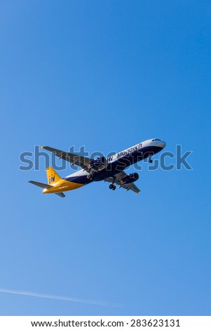 FARO,PORTUGAL-MAY 09 :Monarch Flights aeroplane lands at Faro International Airport,on May 09, 2015 in Faro,Portugal.Monarch is a British airline with 32 jet airliners