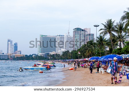 PATTAYA, THAILAND - DECEMBER 02: Local merchant selling souvenirs to tourists at Pattaya beach on December 02, 2013, it is a city in Thailand, a beach resort popular with tourists and expatriates