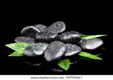 zen stones and leaves with water drops. leaf and basalt stones.
