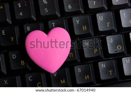 Pink heart on black keyboard
