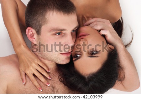Young couple in love lying down in white background (dream)