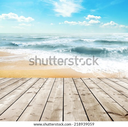 Yellow sand beach and blue sky and sea with wooden floor
