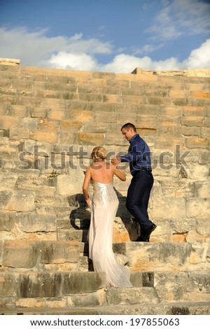 Beautiful elegant couple at a beautiful antique Roman amphitheater.