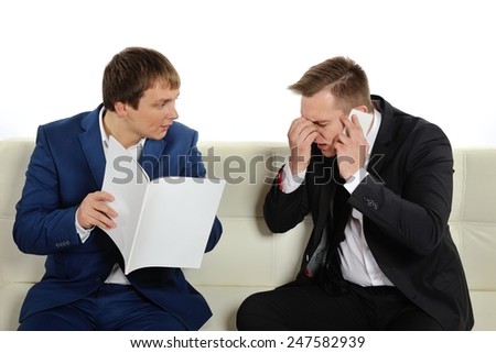 Two men trying to figure out the problems that arise in business.