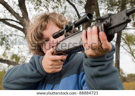 The girl Shooting from a gun. Training shooting from an air rifle in the autumn afternoon