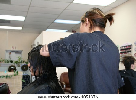 A photo of a woman getting her hair done at the salon