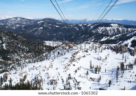 A photo of a gondola lift with a beautiful scenic background