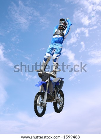 A stunt rider doing tricks on his dirt bike