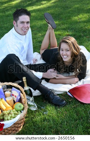 An attractive couple having a Valentines picnic in the park