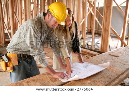 A home designer working with a home builder and inspecting the blueprints