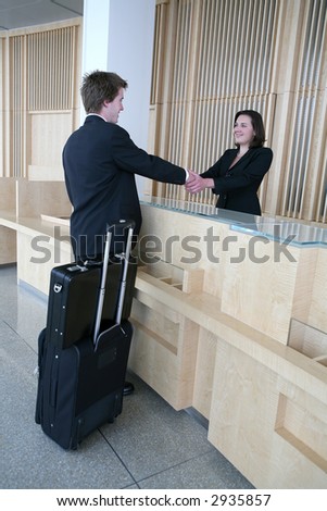 A business man arriving in the lobby for a sales meeting