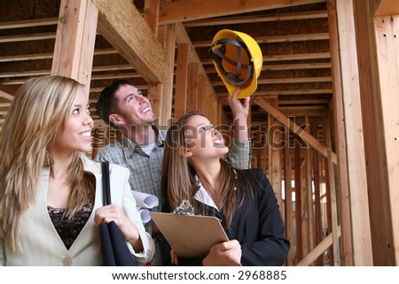 Two women real estate agents celebrating with the construction man