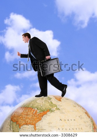 A handsome business man running on a world globe
