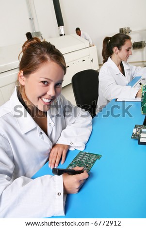 Women technicians working on computer parts in the lab