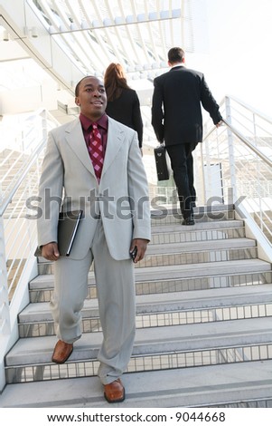 Handsome business man walking down the stairs