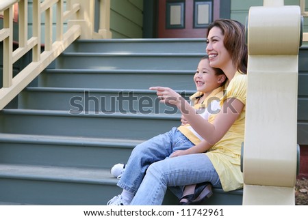 A pretty mother and cute son sitting on porch at home