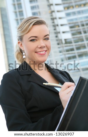 A beautiful blonde business woman outside her office building