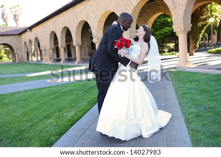 An attractive man and woman wedding couple outside church