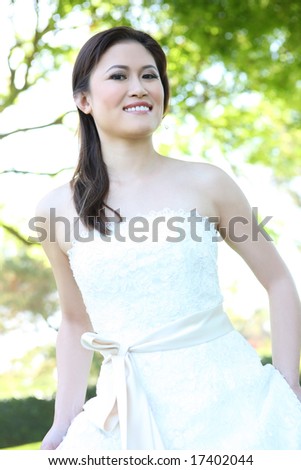 A beautiful young asian bride at wedding ceremony in the park