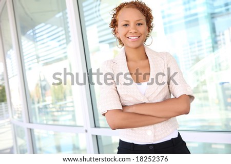 A pretty african american business woman outside office building