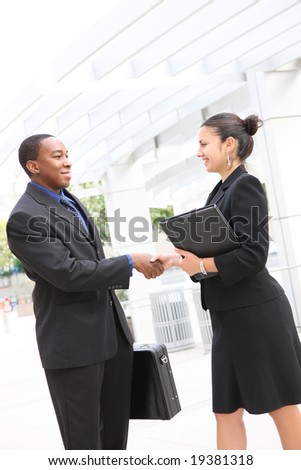 An attractive, diverse, business team man and woman handshake