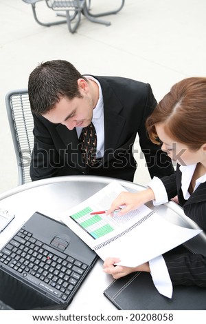 An attractive man and woman business team at office working