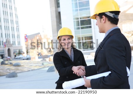 An attractive business construction team shaking hands on the building site