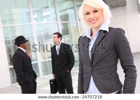 Beautiful business woman with team at the office building