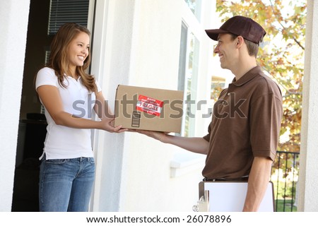 A handsome young delivery man delivering a package