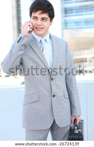 A handsome young business man on the phone at office