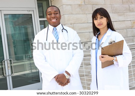 Attractive, diverse medical man and woman team at hospital