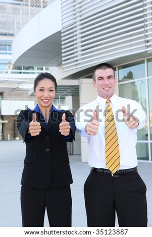Successful happy business man and woman team celebrating