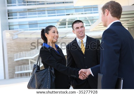 A business man and woman team at office shaking hands
