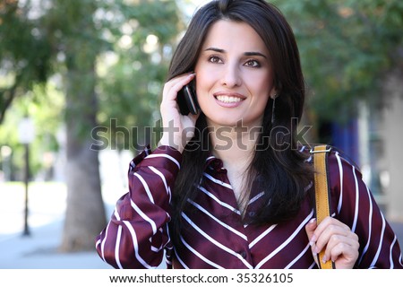 An attractive, young indian business woman on phone