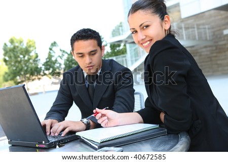 A attractive man and woman business team at office with laptop computer