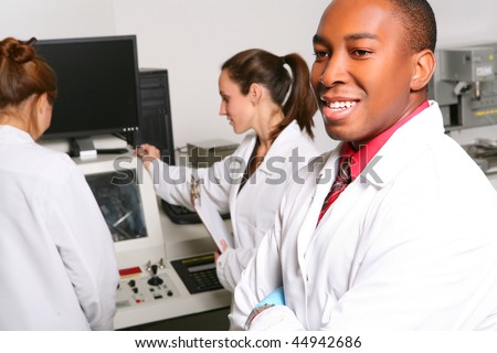 African American Computer Technician in Lab with Women Co-Workers