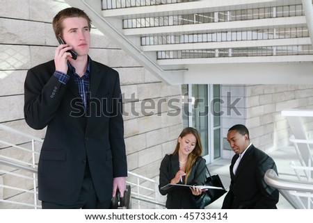 A handsome business man on phone at place of work
