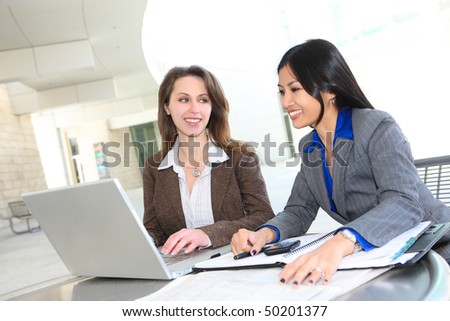 A diverse business woman team at office building on laptop computer