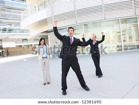A diverse attractive man and woman business team at office building celebrating