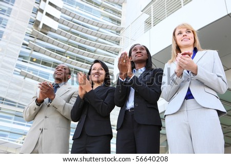 An diverse business man and woman team clapping at office building